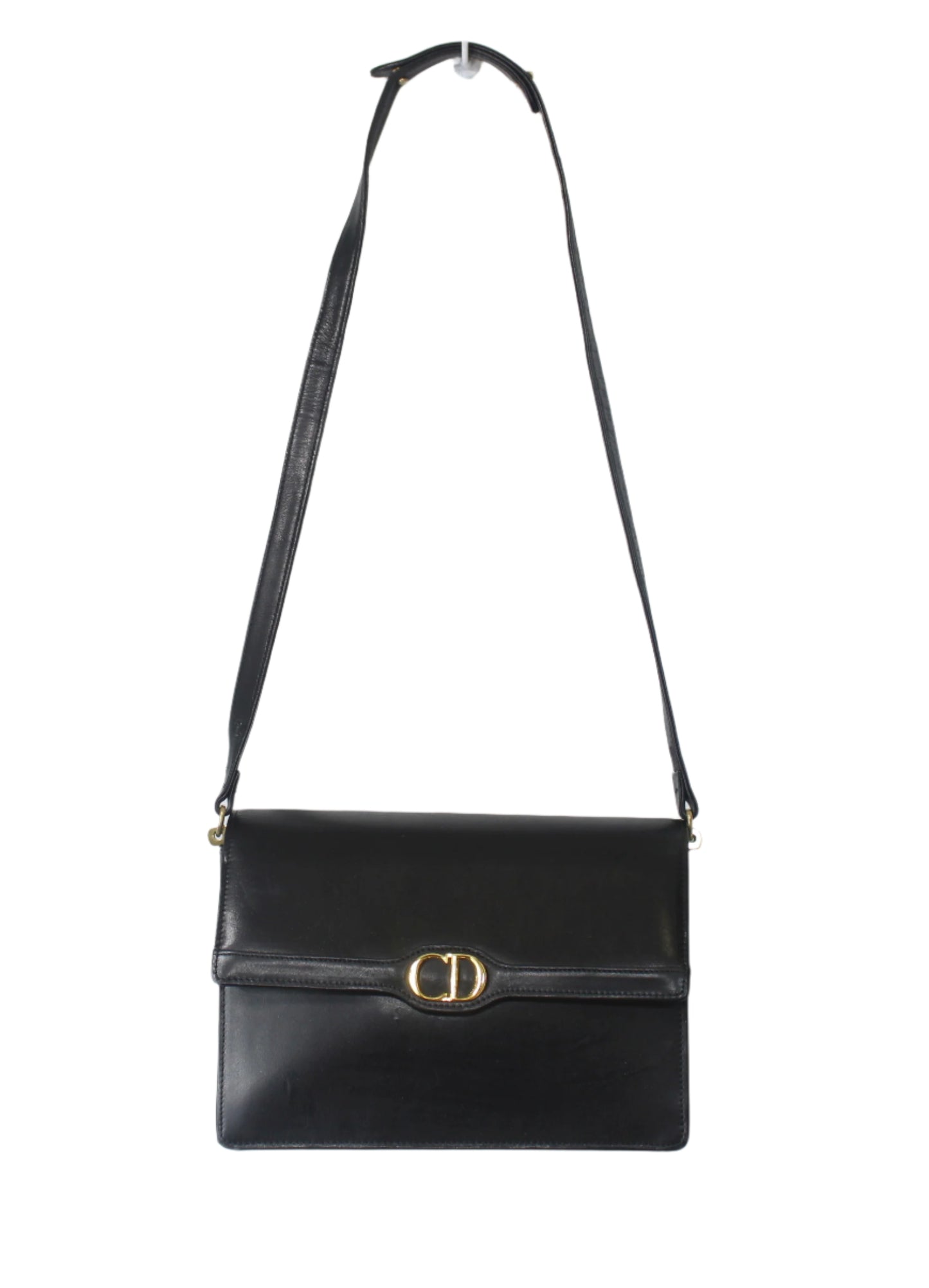 Black shoulder bag with a gold clasp on a light gray background