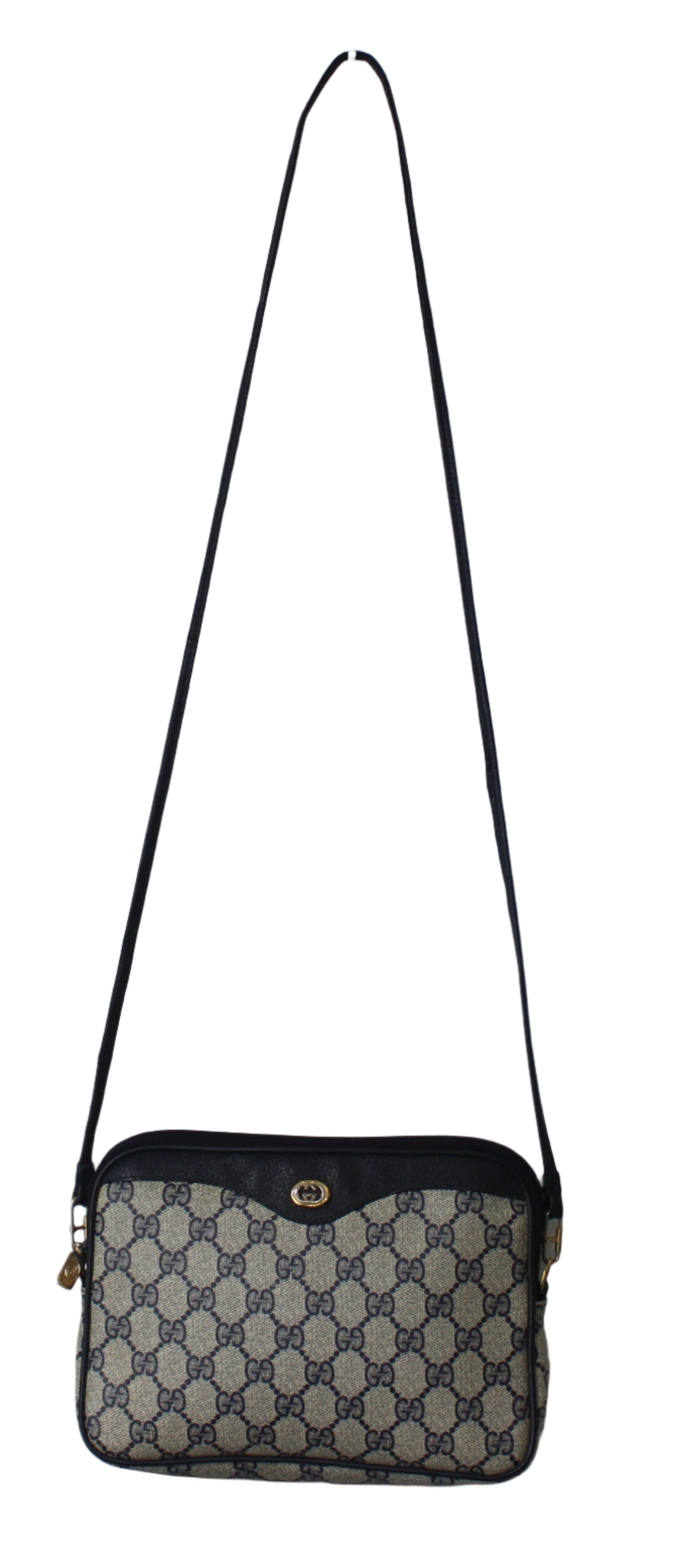 Patterned shoulder bag with a black strap on a light gray background