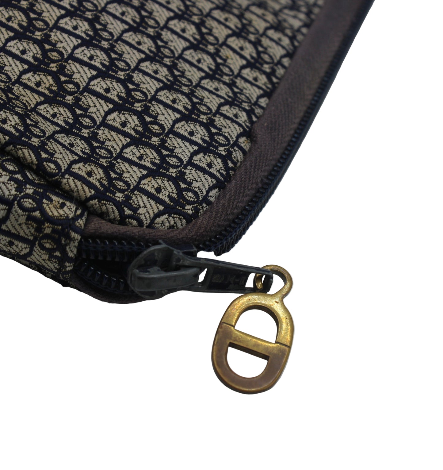 Close-up of a textured pouch with a gold zipper pull on a white background