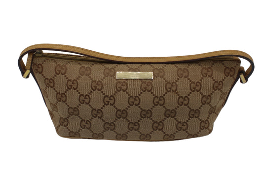 Gucci Beige GG Canvas Leather Trim Small Boat Handbag Brown handbag with a prominent pattern on a white background