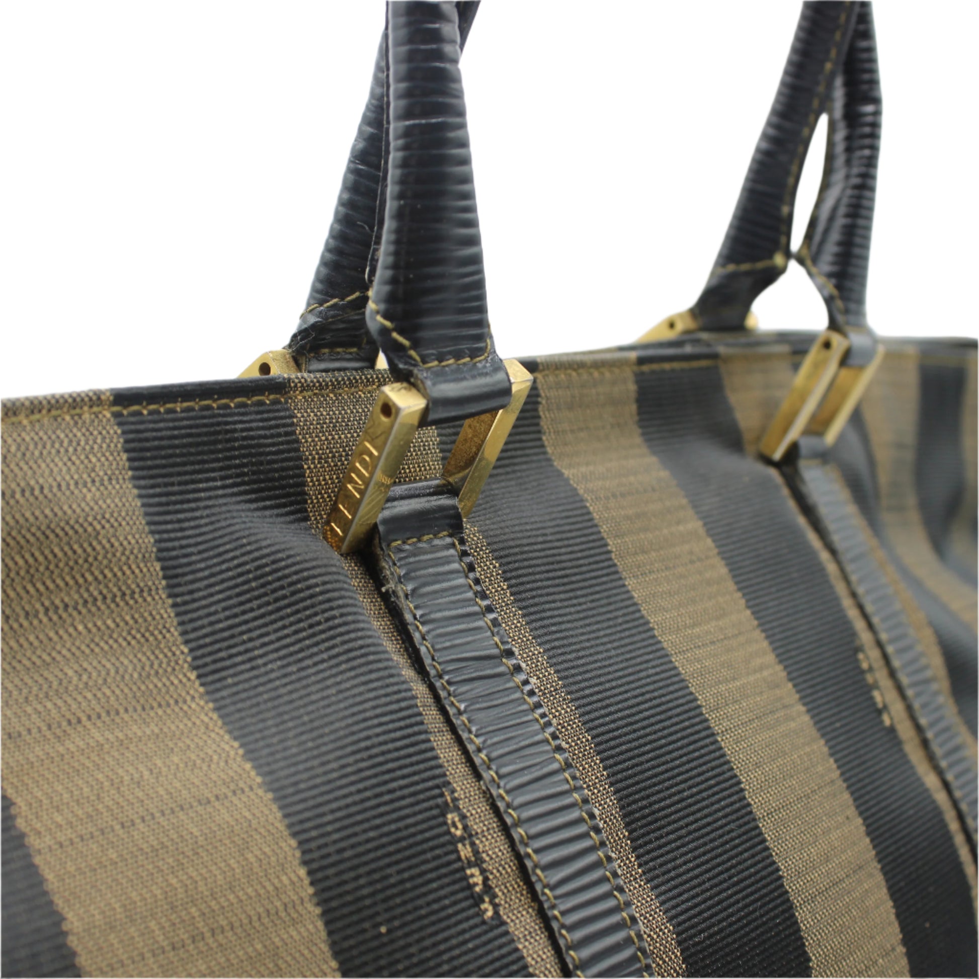 Close-up of a striped handbag with gold accents on a white background
