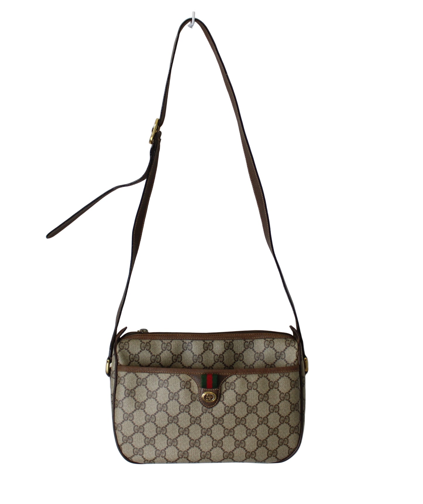 Beige and brown handbag with a visible brand logo on a light gray background