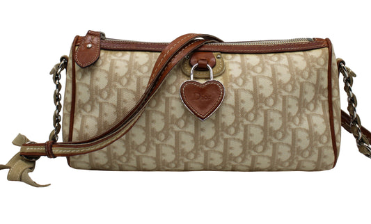 Christian Dior Beige Romantique Heart Charm Shoulder Crossbody Bag Beige handbag with brown leather accents and heart-shaped tag on a white background