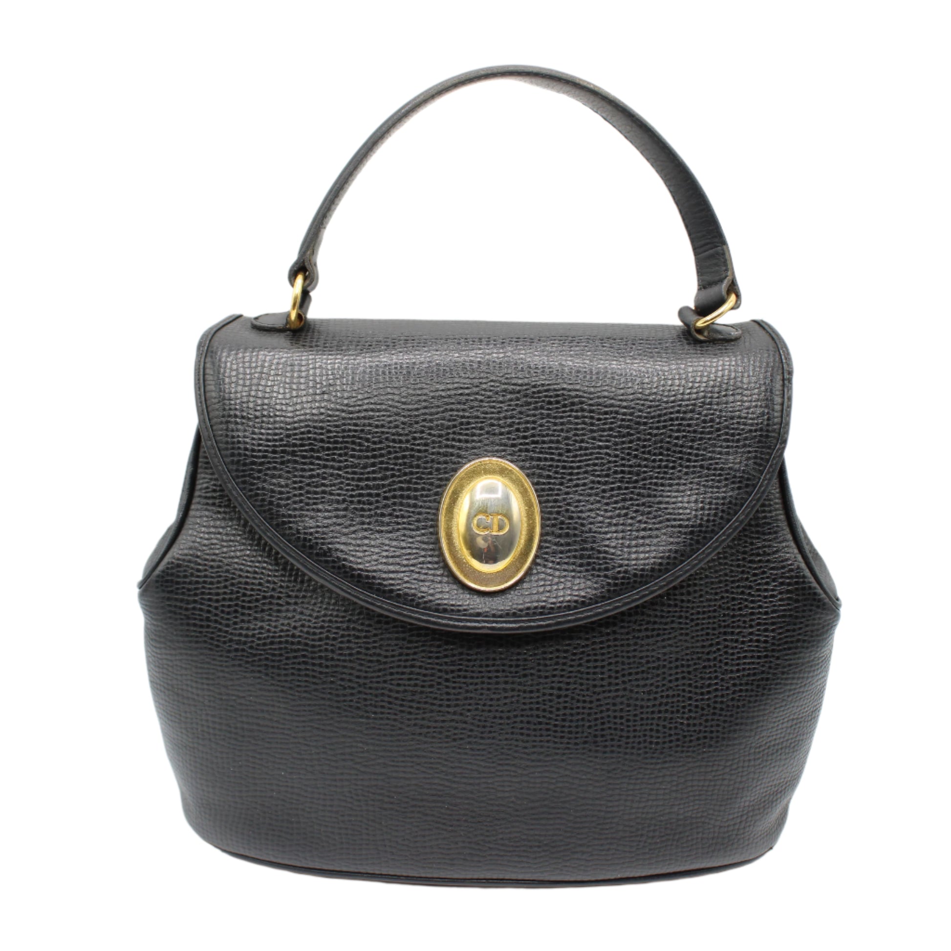 Christian Dior Black Grained Leather 1990s Oval Logo Top Handle Bag Black handbag with a gold clasp on a white background