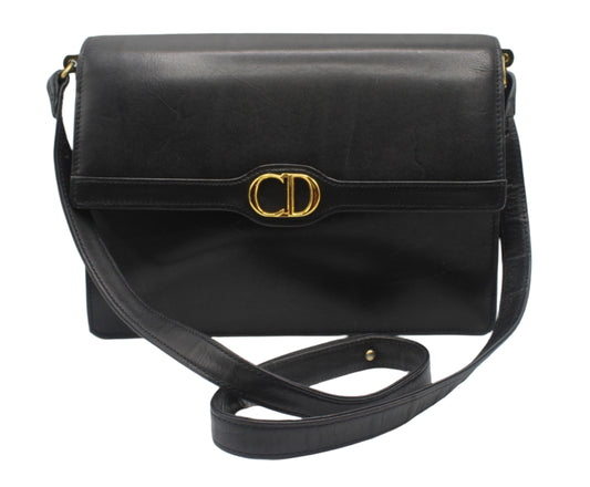 Christian Dior Black Leather CD Logo Crossbody Bag Black handbag with gold clasp on a white background