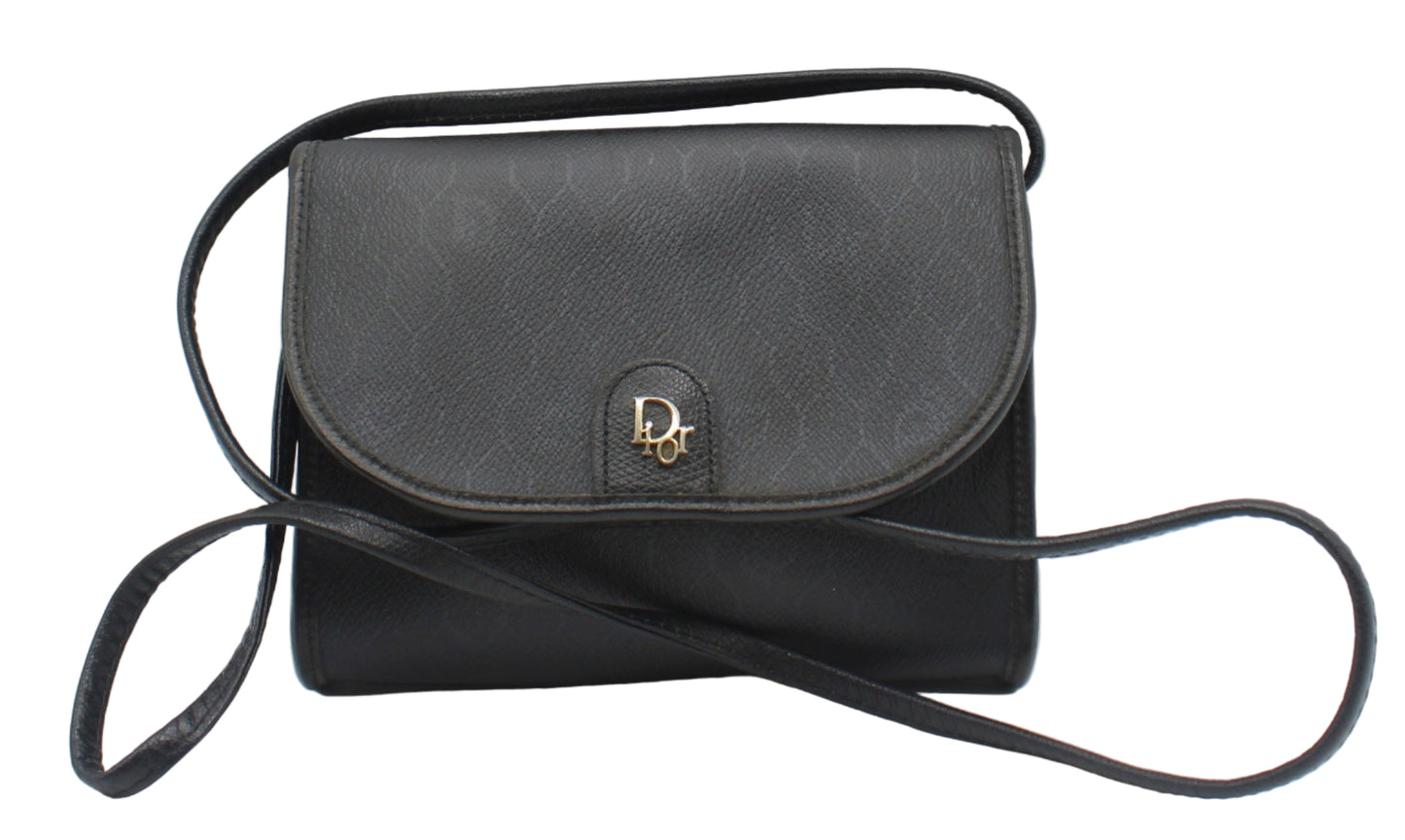 Christian Dior Black Leather Honeycomb Logo Flap Crossbody Bag Black handbag with a strap on a light gray background