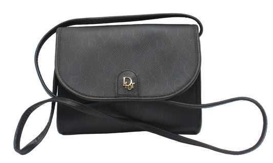 Christian Dior Black Leather Honeycomb Logo Flap Crossbody Bag Black handbag with a strap on a light gray background
