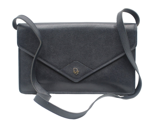 Christian Dior Dark Navy Leather Envelope Crossbody Bag Black leather handbag with a strap on a white background