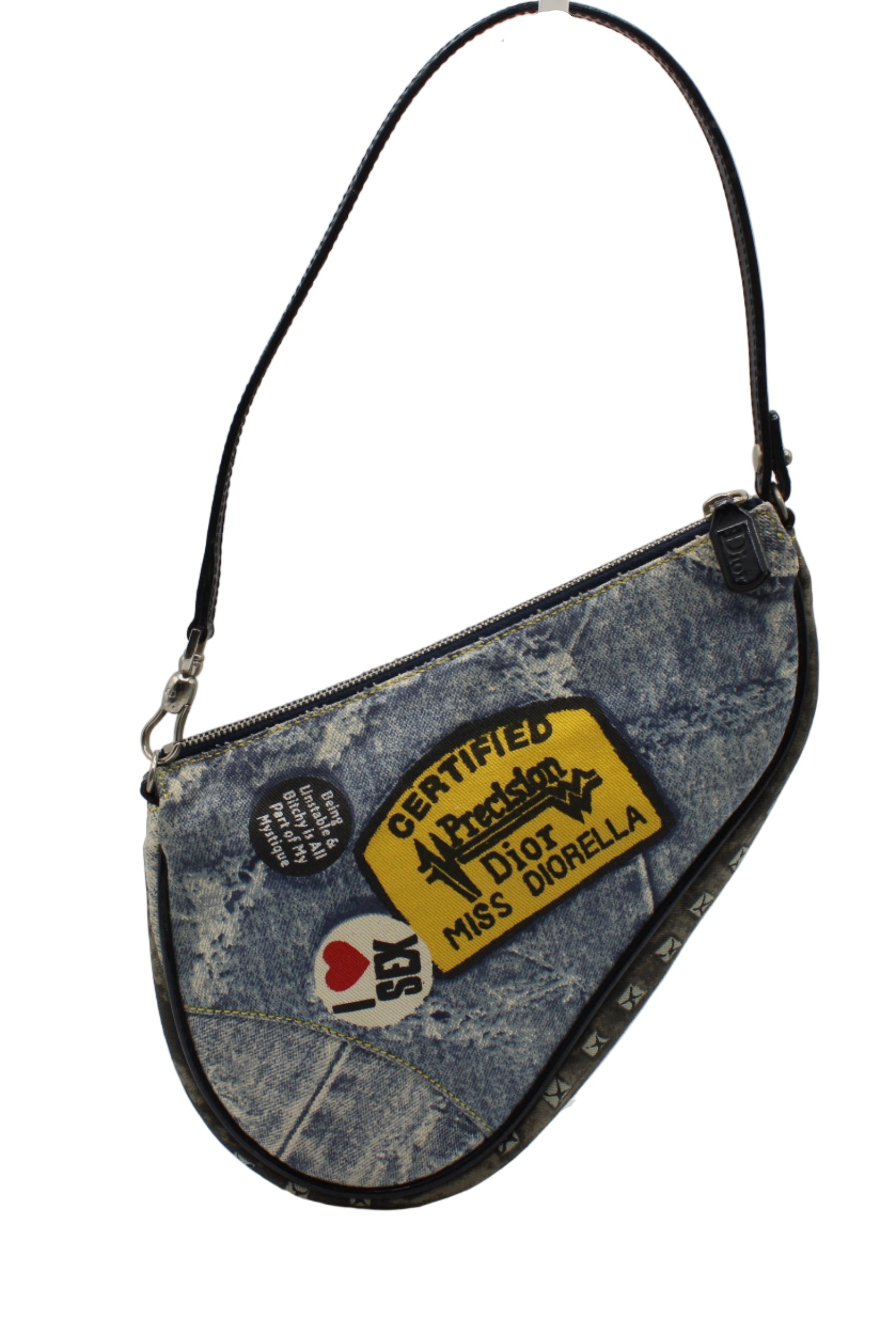 Christian Dior Denim Miss Diorella Saddle Bag Denim handbag with patches on a white background