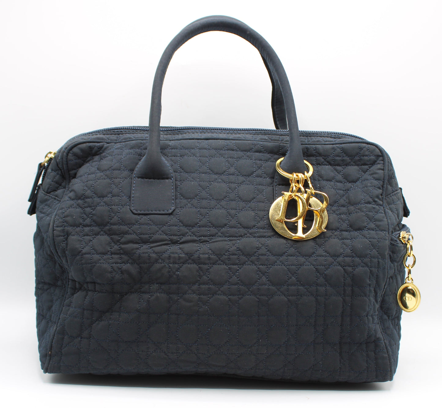 Black quilted handbag with gold Dior logo charm on a white background Christian Dior Navy Cannage Cloth Boston Hand Bag