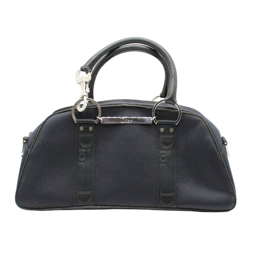 Christian Dior Navy Canvas Rhinestone Handle Handbag Black handbag with 'Dior' branding on a white background
