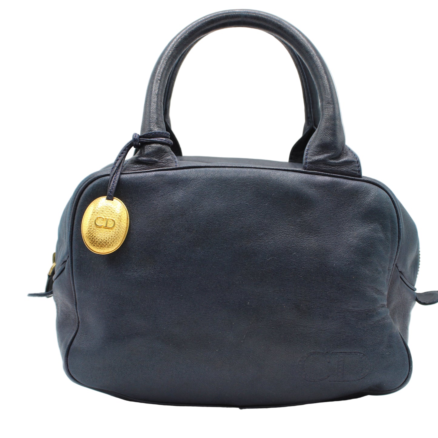 Christian Dior Navy Lambskin Leather Gold Charm Boston Bag Navy blue handbag with a gold emblem on a white background
