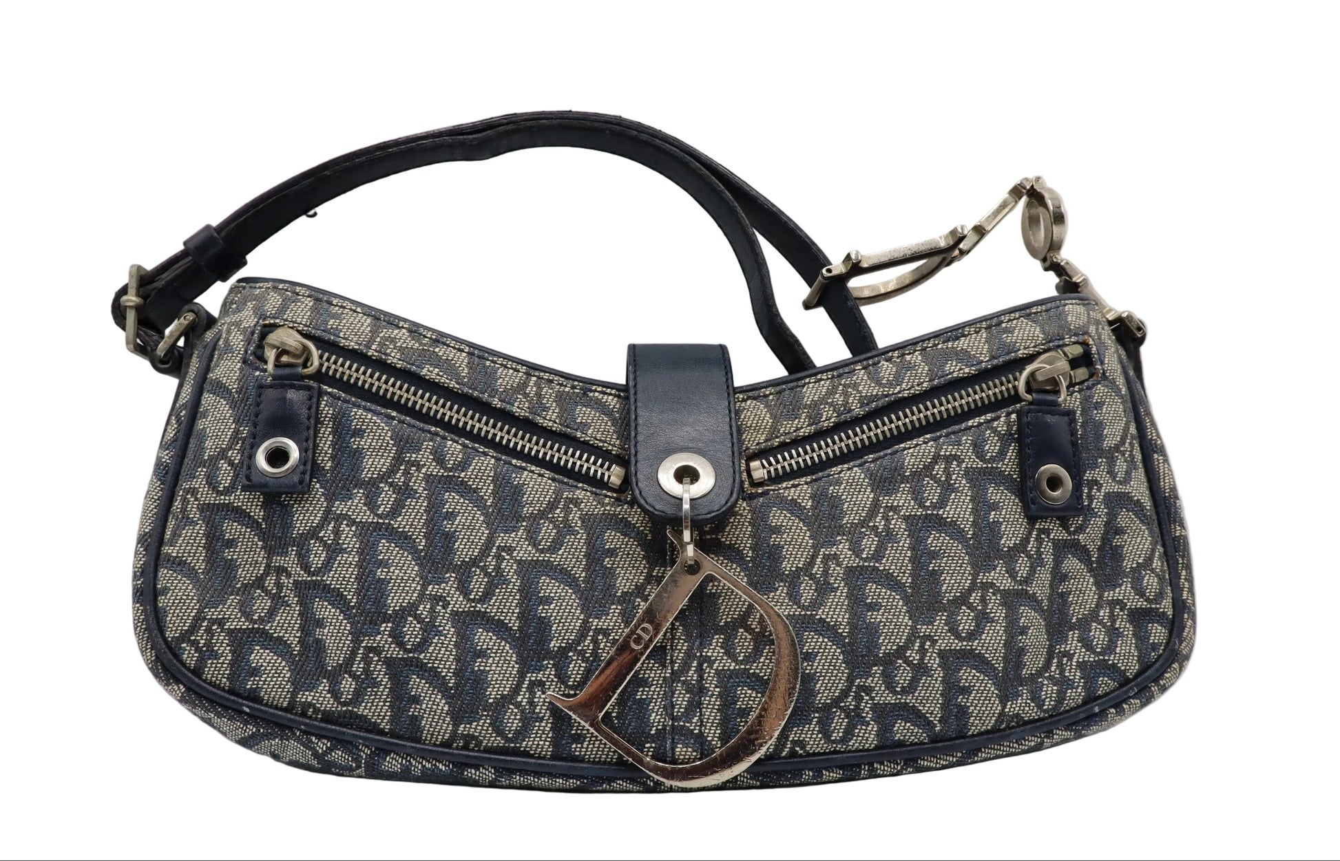 Christian Dior Navy Trotter Oblique Canvas Flap Shoulder Bag A Dior monogram shoulder bag in navy blue and beige canvas, featuring a dark navy leather strap, silver-tone hardware, and a hanging Dior key tag, photographed on a light gray background.