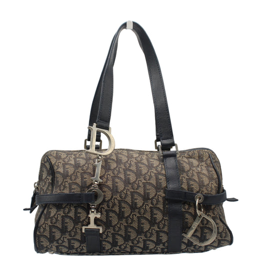 Christian Dior Trotter Canvas And Leather Navy Hand Bag Designer handbag with monogram pattern on a stand against a light gray background
