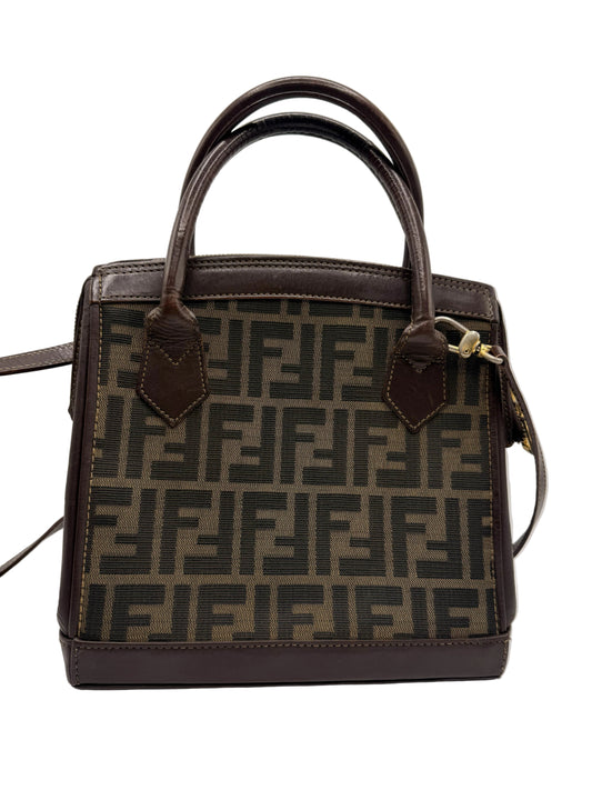 Fendi Brown Zucca Canvas Leather Tote Bag A Fendi handbag in the signature Zucca monogram canvas with dark brown leather trim and handles, shown against a plain light gray background.
