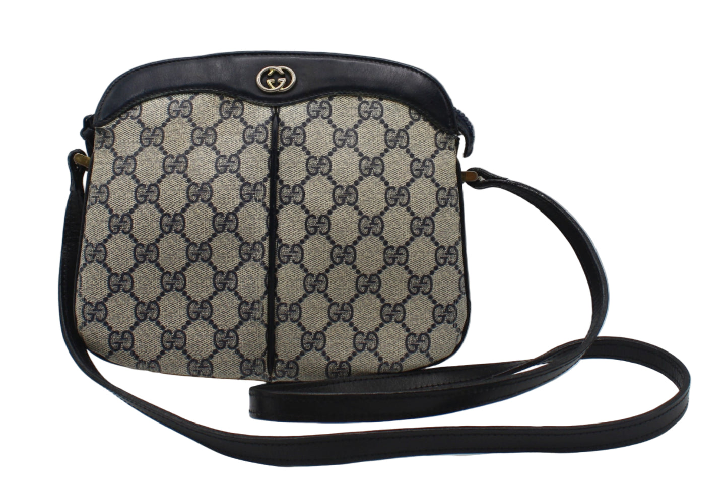 Gucci Beige And Navy GG Canvas Leather Trim Crossbody Bag Designer handbag with patterned fabric and black leather accents on a light gray background