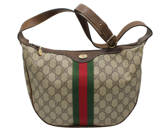Designer handbag with monogram pattern and red and green stripe on a white background