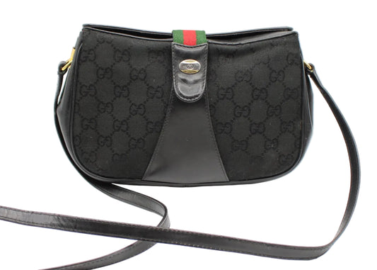 Gucci Black GG Canvas Leather Trim Crossbody Bag Black Gucci handbag with signature pattern on a white background