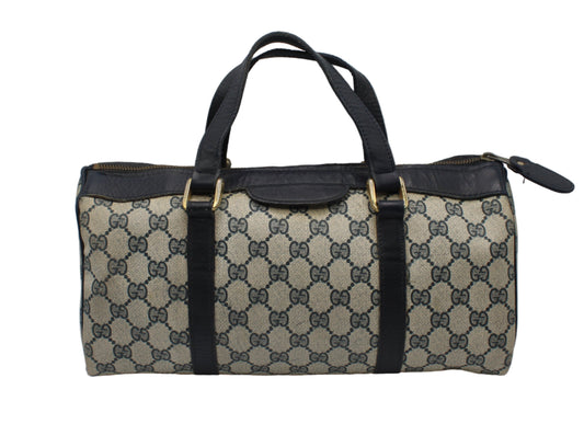 Gucci Blue GG Canvas And Navy Leather Mini Boston Bag Designer handbag with patterned fabric and black accents on a gray background