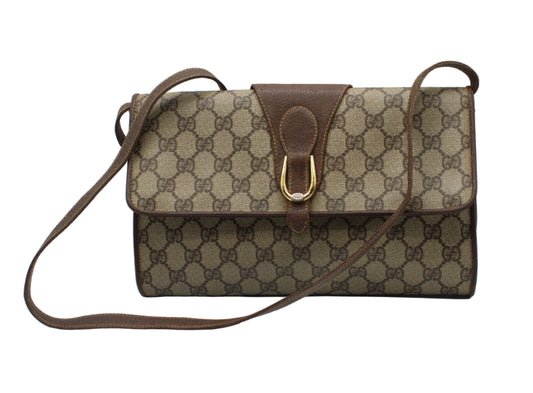 Designer handbag with brown and beige pattern on a white background Gucci Brown GG Canvas Leather Flap Crossbody Bag