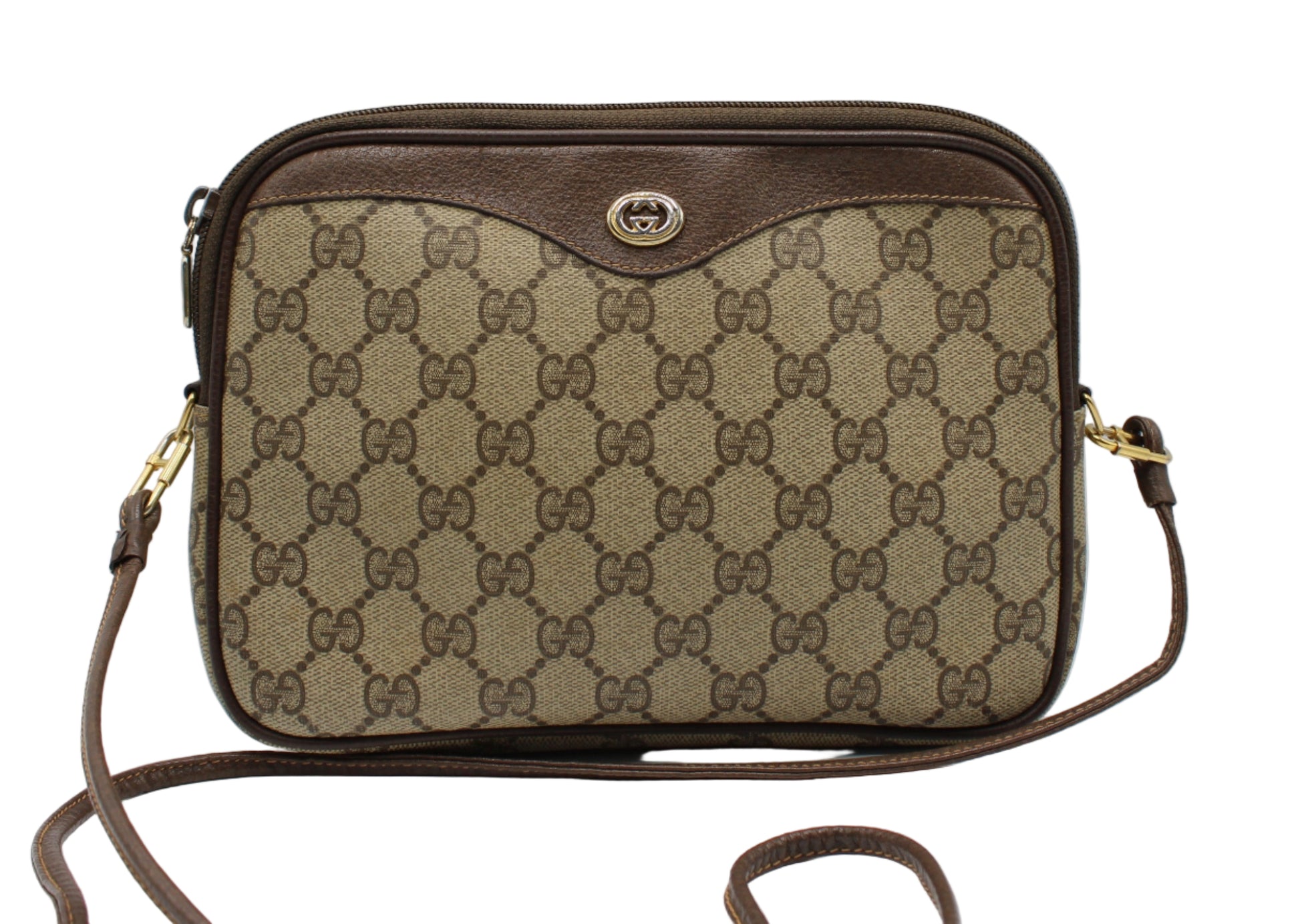 Brown Gucci handbag with patterned surface on a white background
