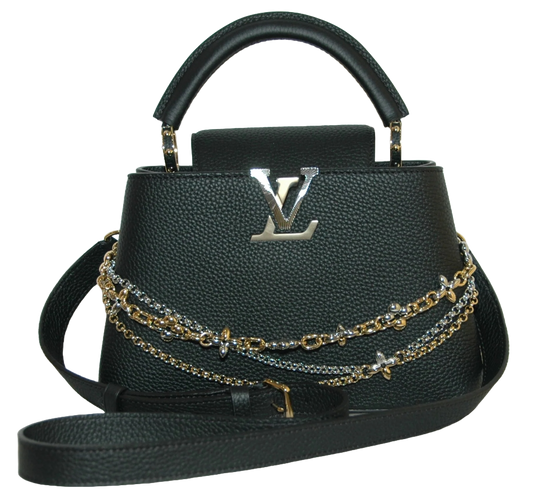Black handbag with gold chains and Louis Vuitton logo on a white background