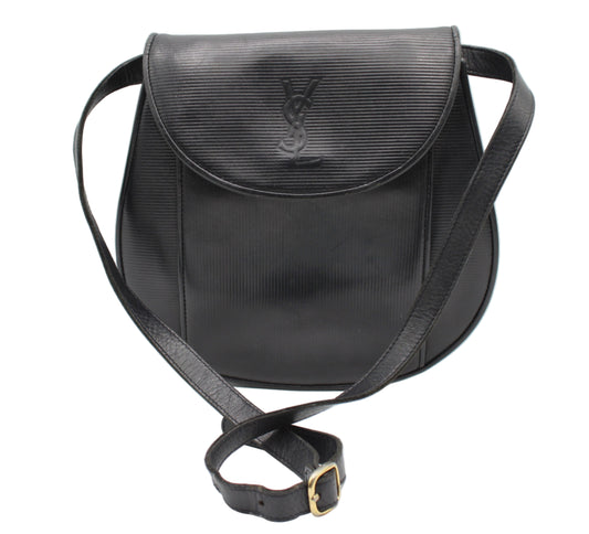 Yves Saint Laurent Black Leather Crossbody Flap Bag Black textured handbag with a brand logo on a white background
